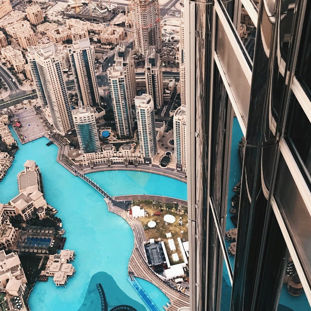 Modern Dubai building exterior, bright sunlight, architectural lines, premium property